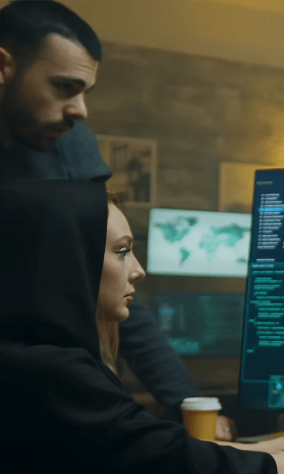 Team members analyzing cyber data on screens